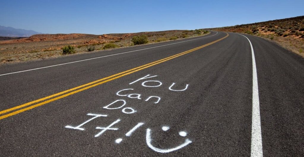 A road with a message saying "You can do it!" drawn on it