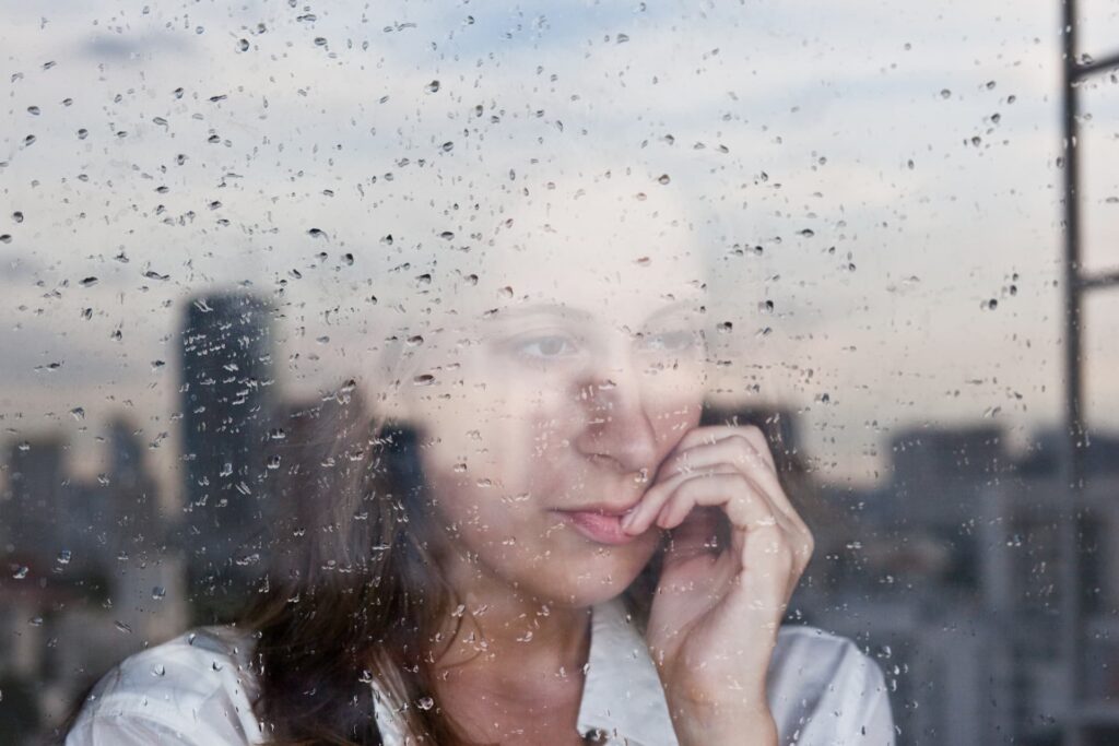 A woman looking pensively out of a window