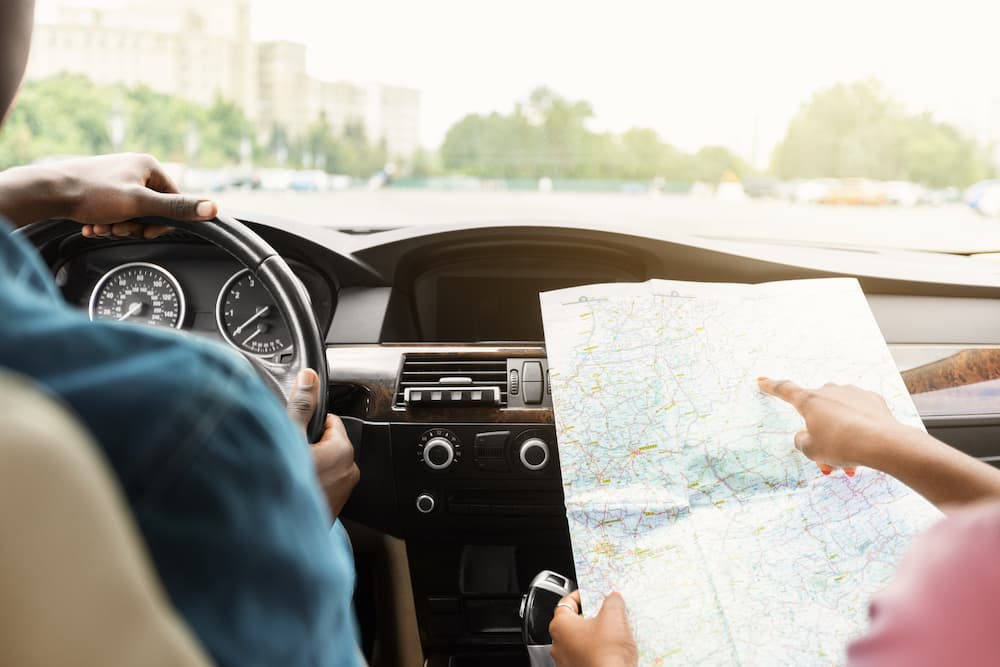 Two people on a journey and one is holding a map